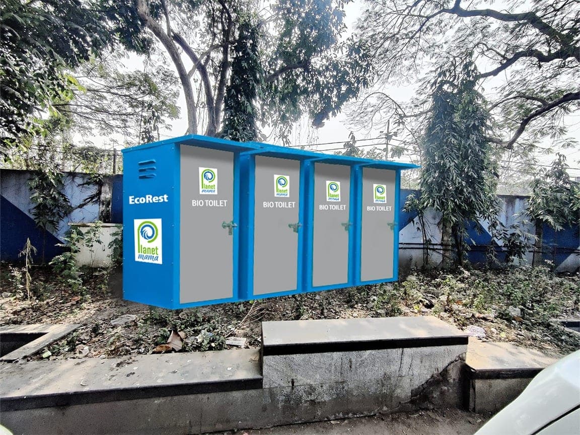 A row of blue EcoRest bio-toilet units carrying the Planet Mama logo, installed on site