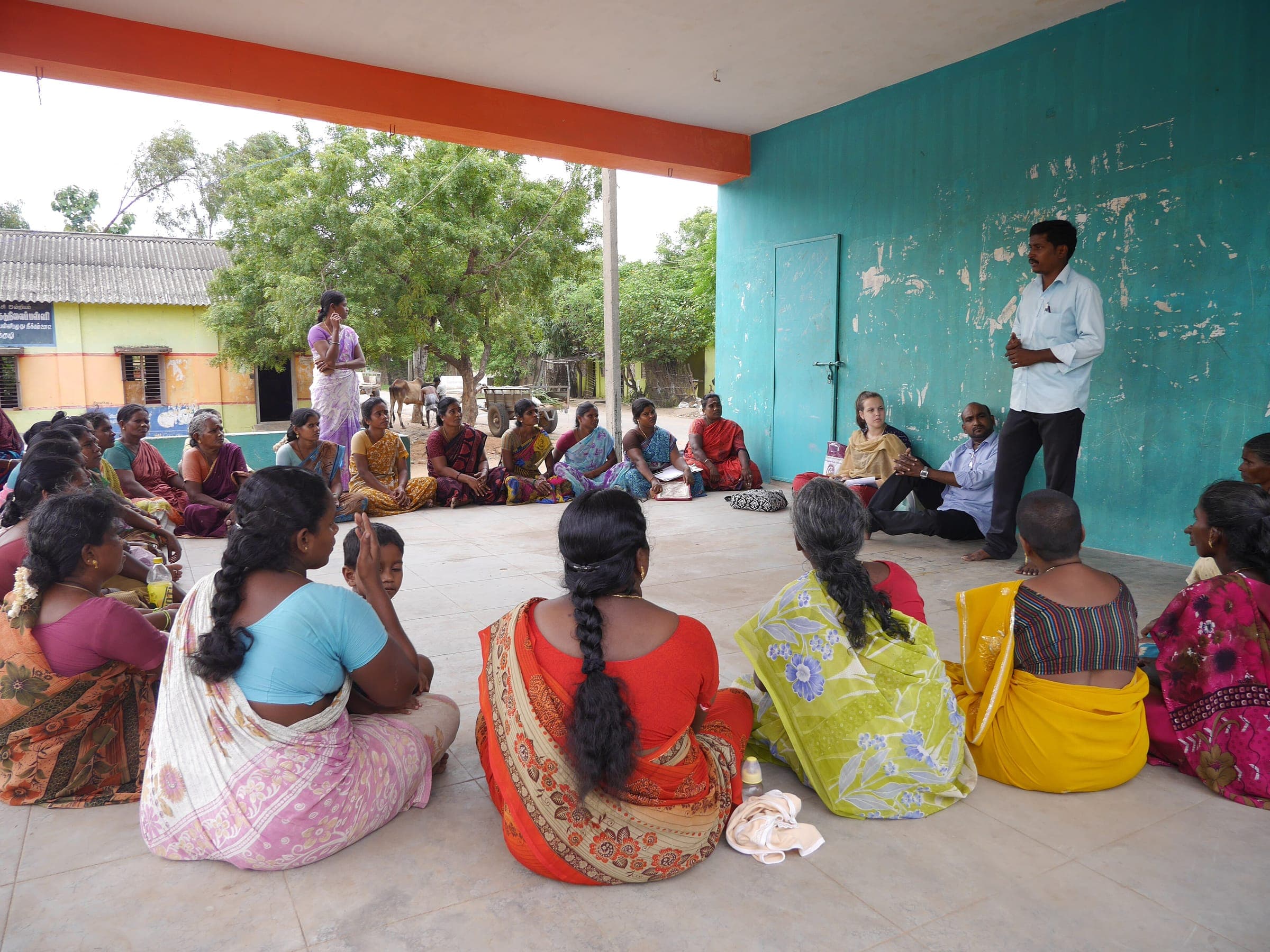 Women seated together at a community meeting